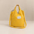 Nerakcos Yellow Bouclé Bucket Bag - front view with crossbody strap