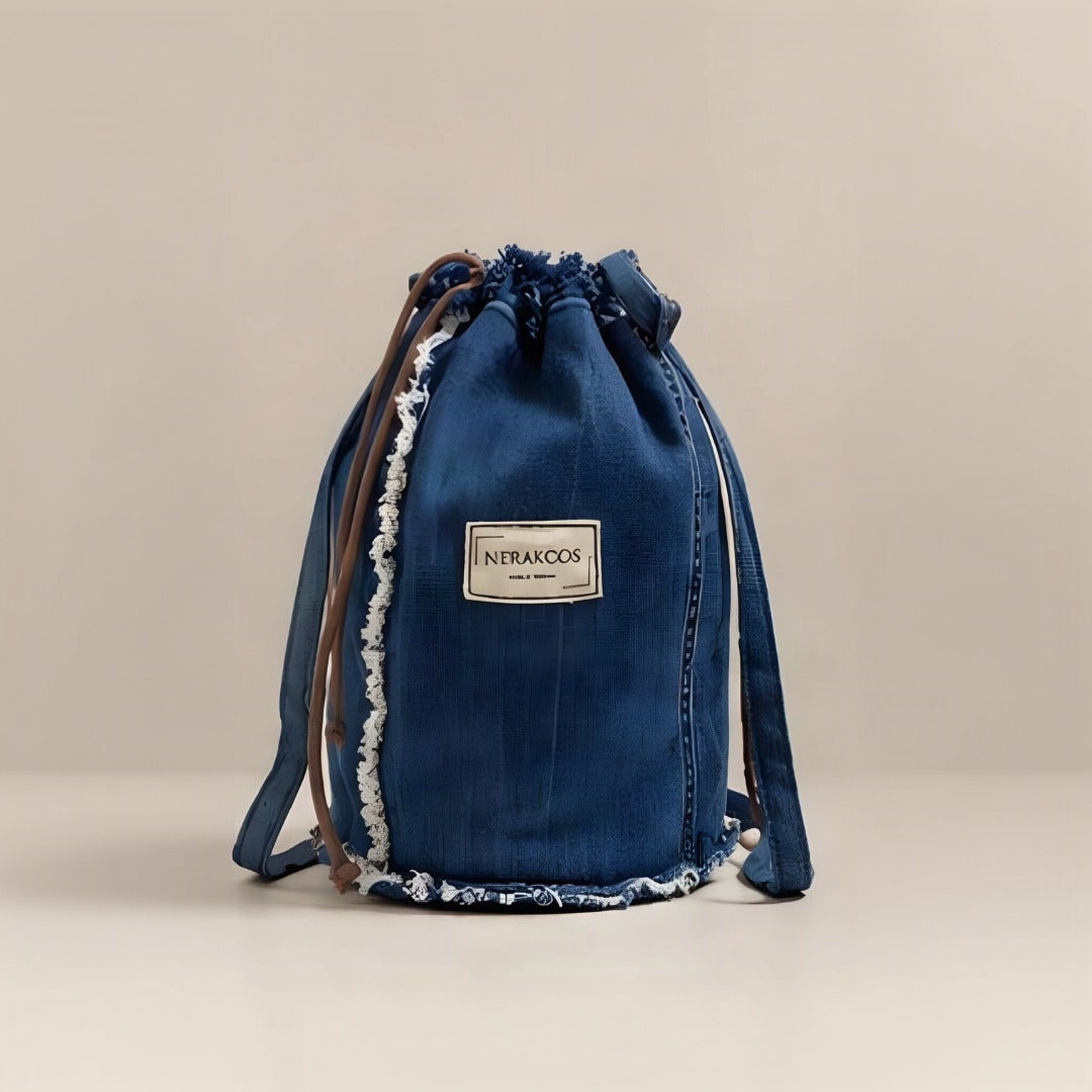 Inside view of Nerakcos upcycled denim bucket bag showing blue lining and zip pocket