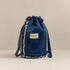 Inside view of Nerakcos upcycled denim bucket bag showing blue lining and zip pocket