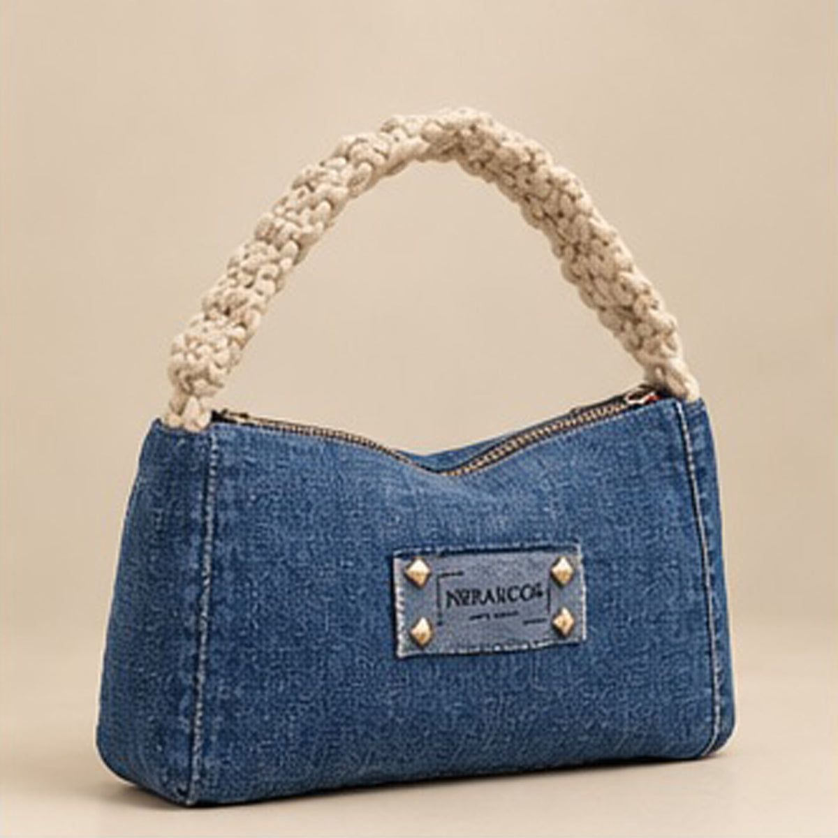 Lifestyle view of a woman holding the denim baguette bag by its cream handle