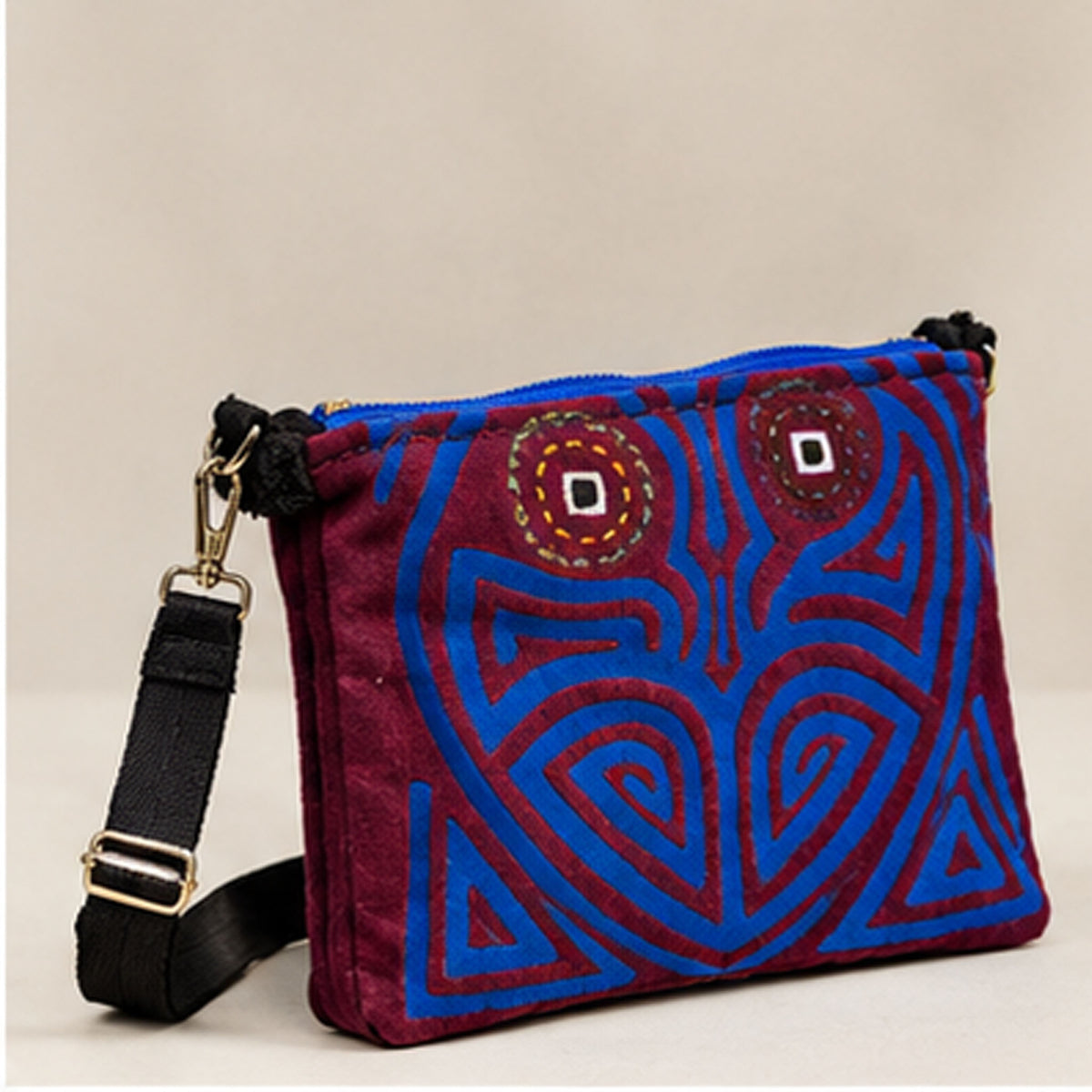 Front view of the burgundy and cobalt-blue embroidered crossbody bag