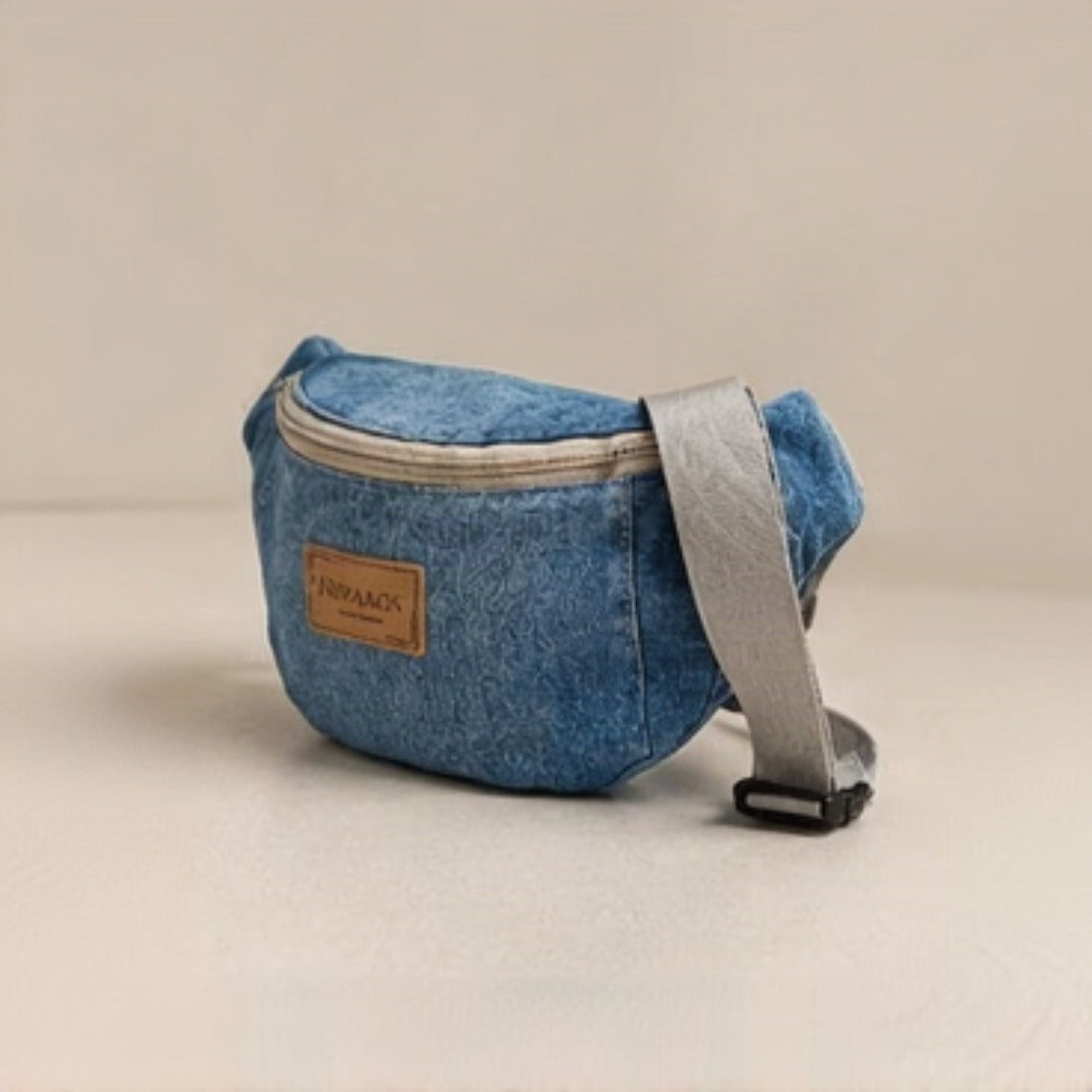 Close-up of Nerakcos tan leather label on textured upcycled denim body