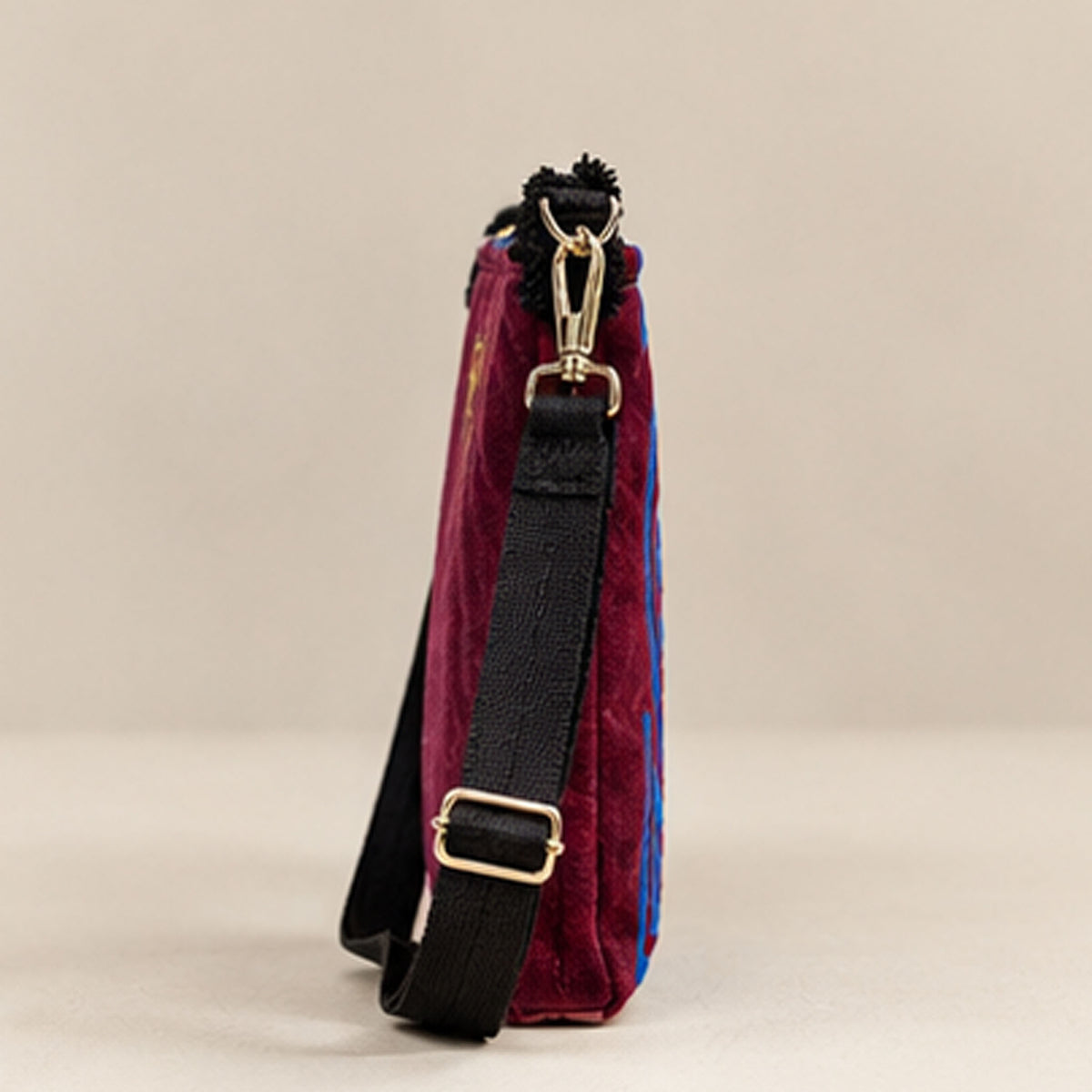 Angled front view showing the embroidered pattern and adjustable strap