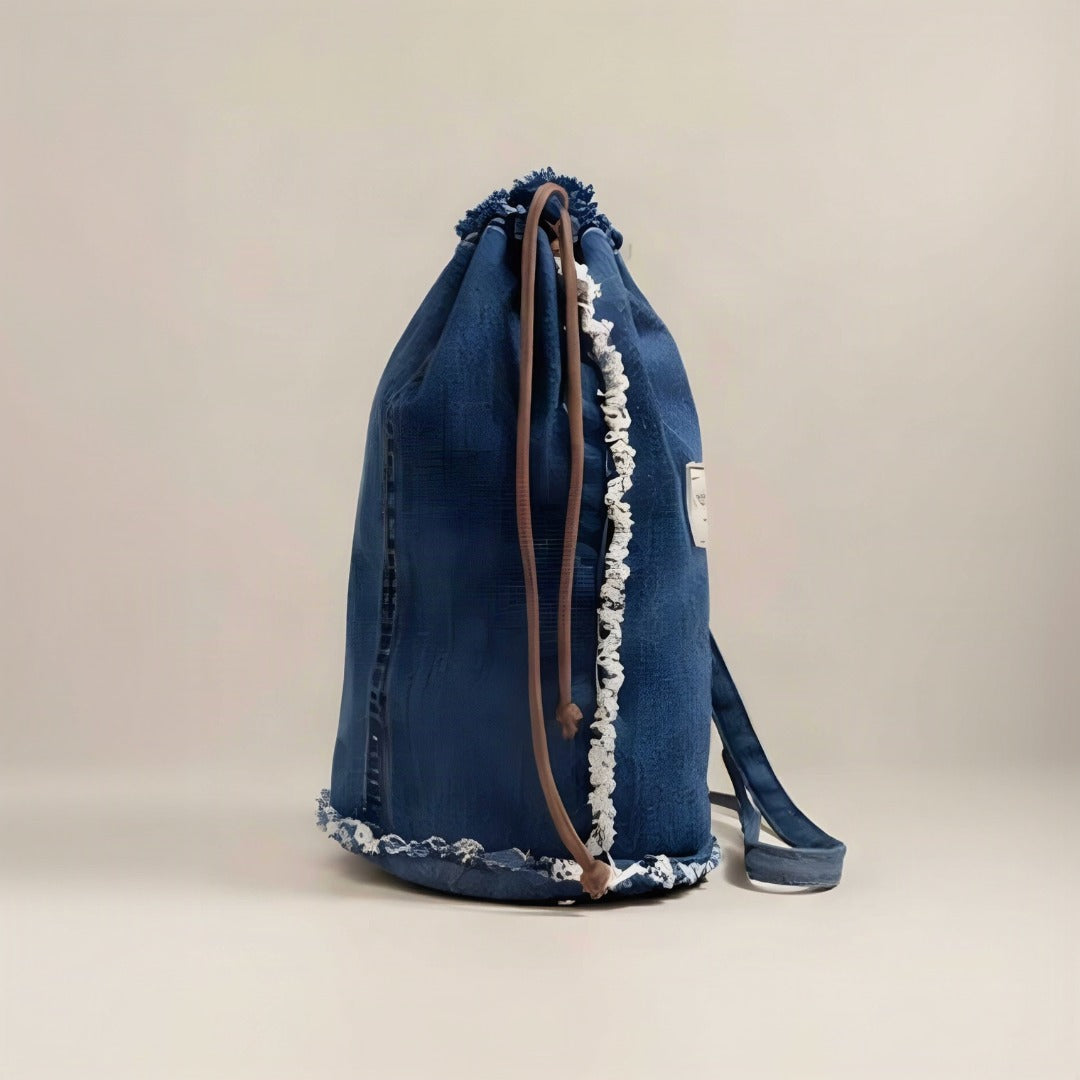 Model wearing Nerakcos denim bucket bag as crossbody