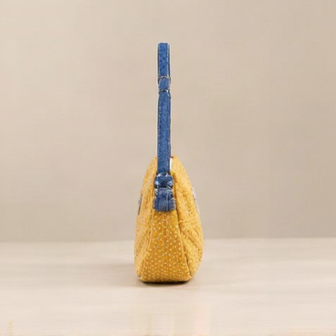 Close-up of Nerakcos frayed label on yellow bouclé fabric texture