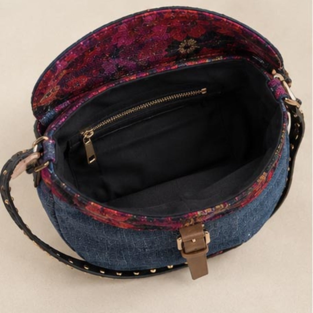 Close-up of frayed denim Nerakcos label with red X corner stitching - Made in Pakistan