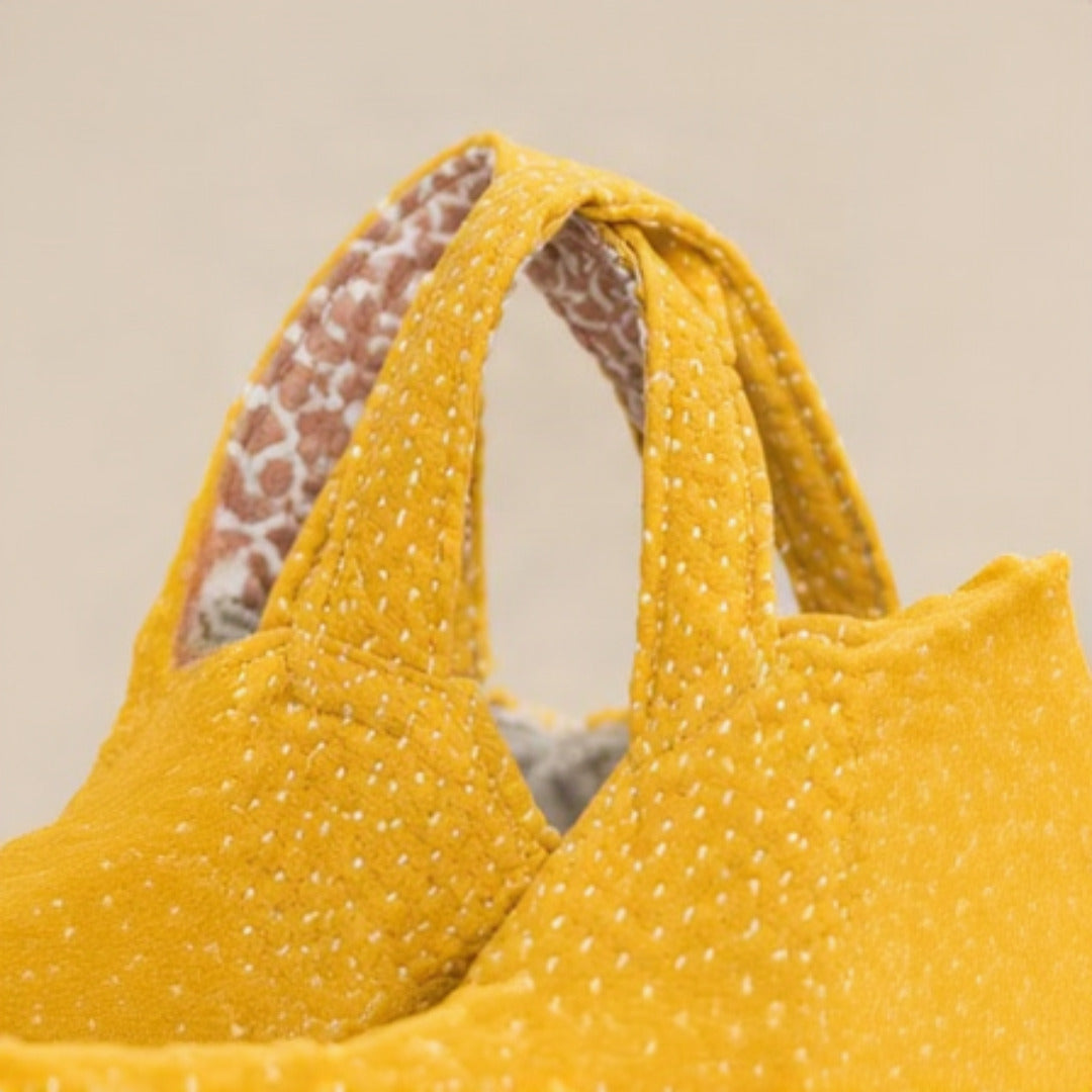 Handle close-up showing dual top handles and floral lining reverse