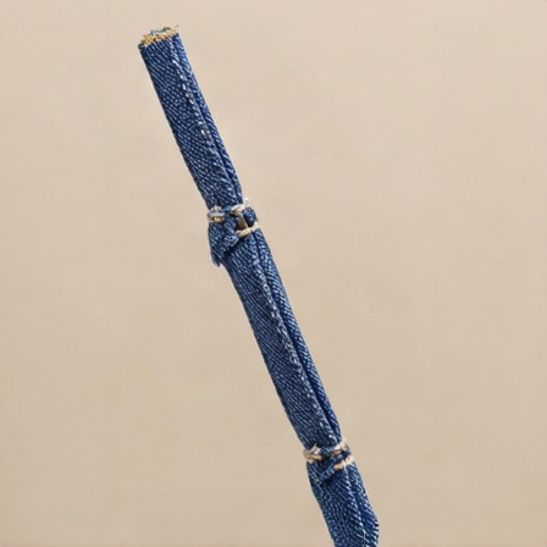 Detail of zip closure and denim strap attachment hardware