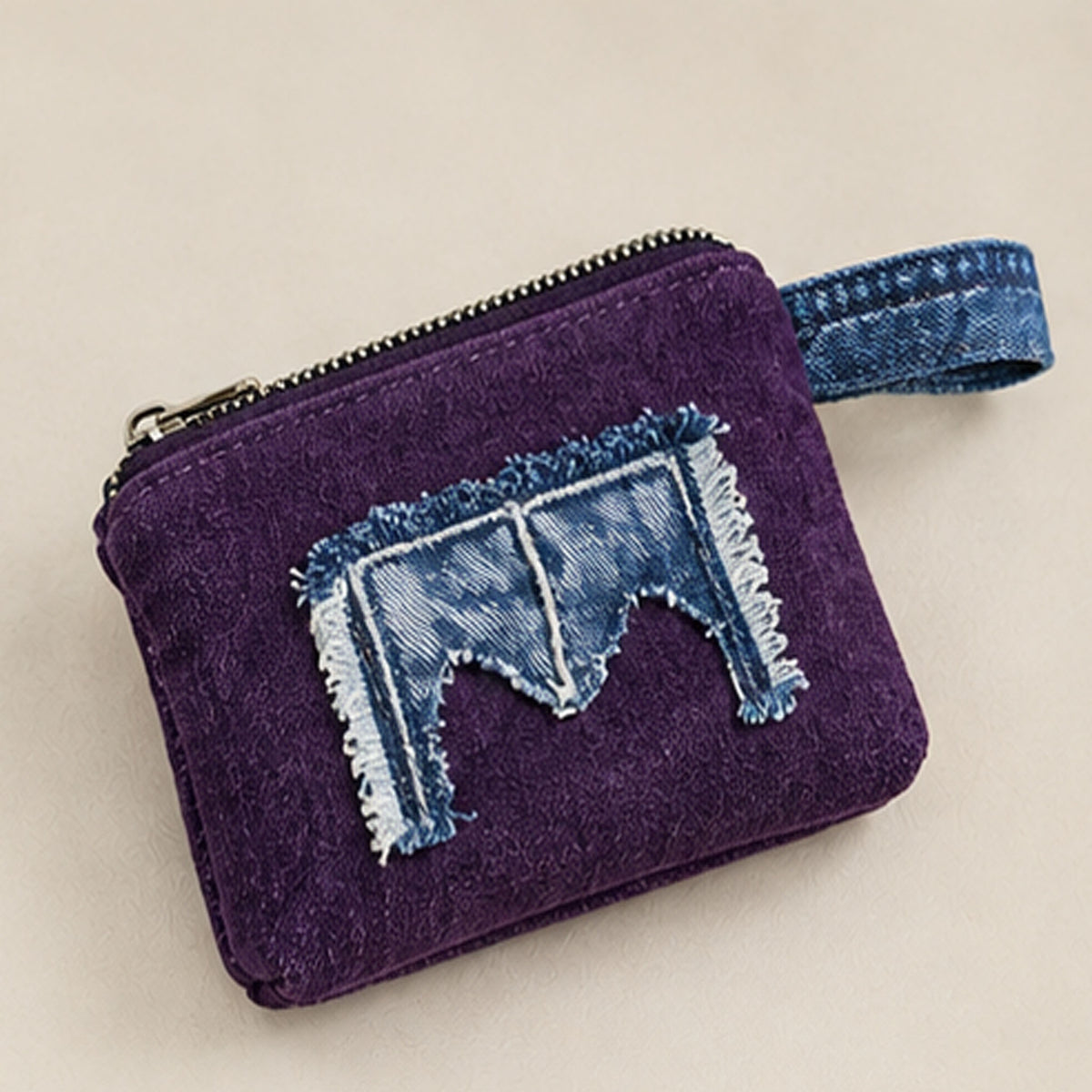 Close-up of frayed denim appliqué and contrasting stitching