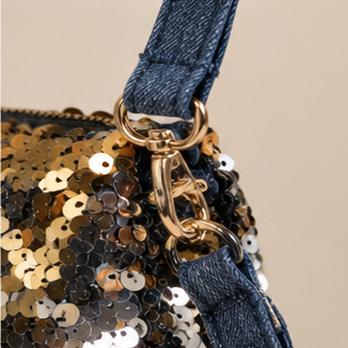 Close-up of frayed denim Nerakcos label - Made in Pakistan on gold sequin background