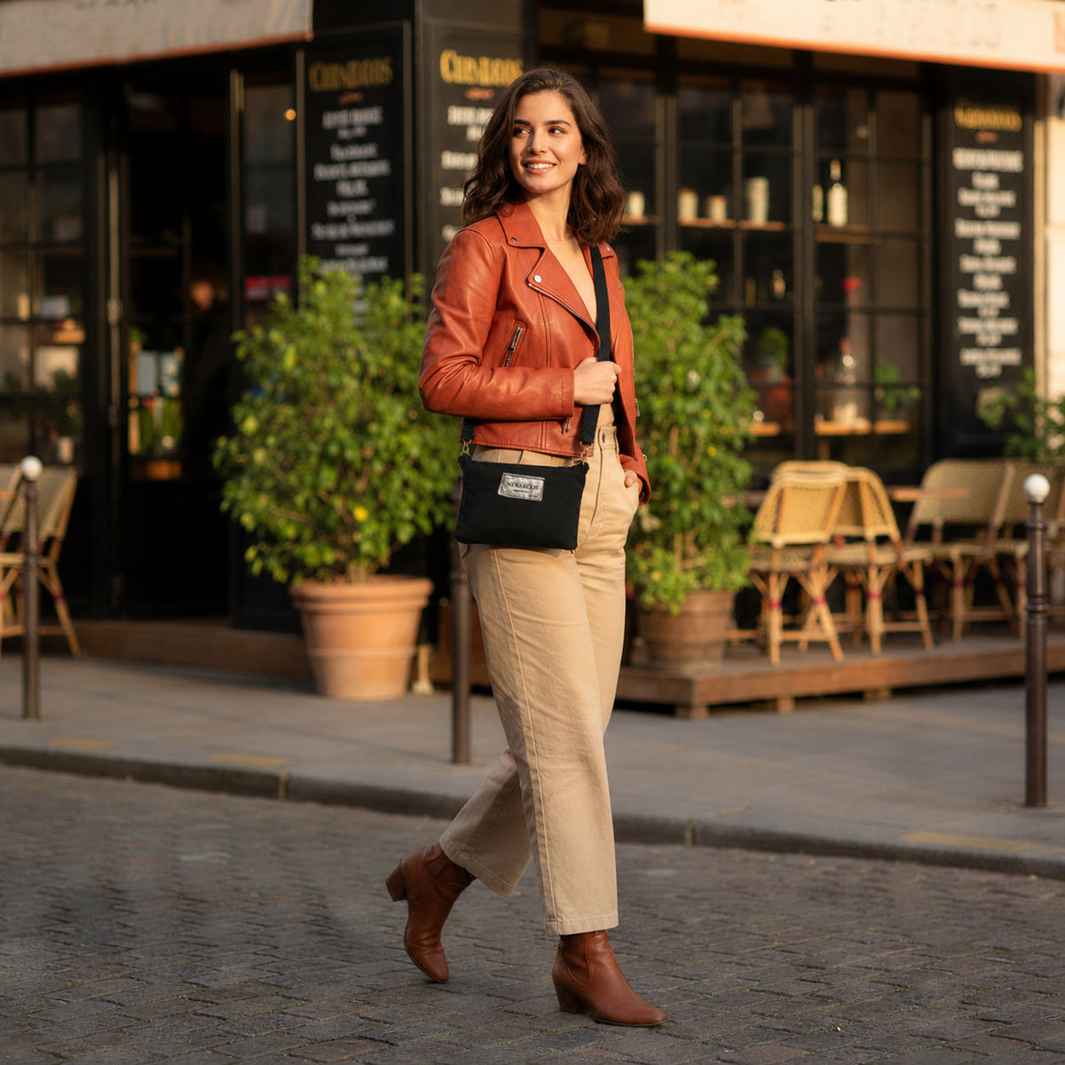 Lifestyle - model wearing Nerakcos Black Denim Crossbody Bag crossbody, full outfit view outside Paris café